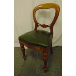 A Victorian beech wood spoon back chair with leather upholstery on carved baluster legs