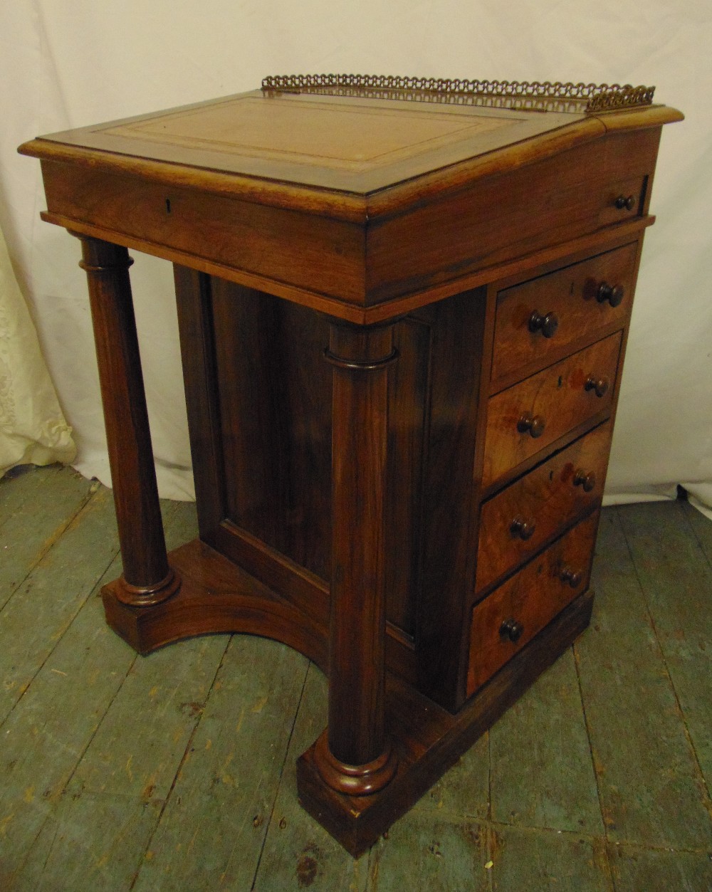 A Victorian mahogany Davenport of customary form with tooled leather hinged top, five drawers on