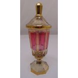 A continental facet amethyst coloured vase with gilded decoration, raised pull off cover on