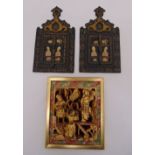 A pair of Middle Eastern papier-mâché rectangular mirrors with hinged doors decorated with figures