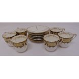 A set of six continental cups and saucers decorated with scrolls and gilding