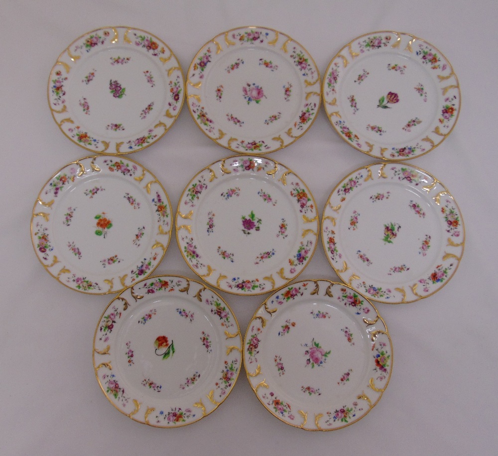 A set of eight continental fruit plates decorated with flowers and gilded borders