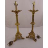 A pair of brass lamp stands of knopped tubular form on pierced triform bases, 74cm (h)