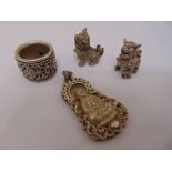 Chinese white metal Archers ring, a pair of white metal figurines of Dogs of Foe and a pendant (4)