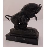 A cast bronze figural group of a lioness attacking a bull on naturalist base mounted on