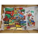 A quantity of play worn Dinky and Matchbox diecast cars, trucks and farm vehicles, some circa 1950