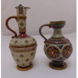 A Mettlach ceramic wine ewer with hallmarked silver spout and hinged cover and a matching water jug,