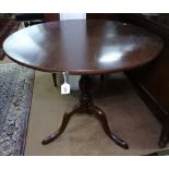 An Antique mahogany tilt-top circular table on tripod base, W85cm