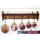 A set of 5 graduated copper pans, on oak rack, rack length 100cm