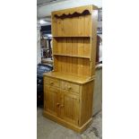A polished pine 2-section kitchen dresser, W91cm, H200cm