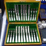A late Victorian cased set of dessert knives and forks for 12 people, with engraved blades and