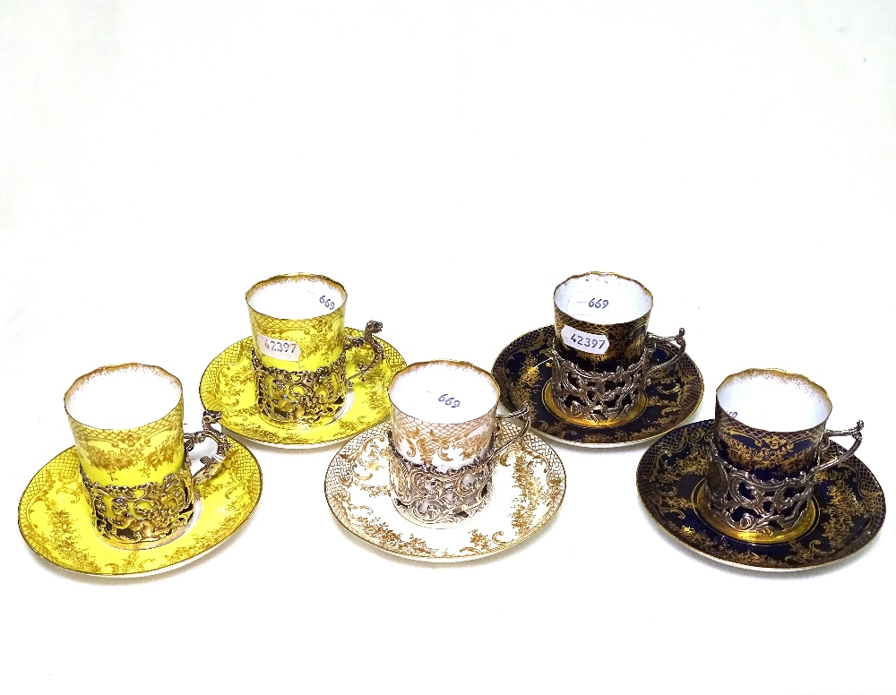 A set of 5 Victorian Crown Staffordshire "Eggshell" cups and saucers in pierced silver holders