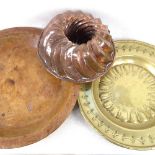 A wooden dish, 38cm, an Antique embossed and engraved brass dish, and a copper jelly mould