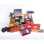 A box of advertising tins, games and leather wallets