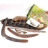 Tula board, a Tribal carved wood boomerang, an embroidered textile, etc.