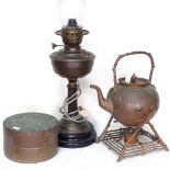 A copper kettle on stand, a brass oil lamp, and a Chinese cylindrical copper box, diameter 18cm (3)