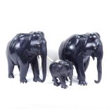 A set of 3 carved ebony elephants, tallest 25.5cm