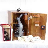 A student's microscope in fitted wooden case, with slides, and a small Eclipse microscope