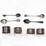 4 various silver napkin rings, and 4 various silver teaspoons