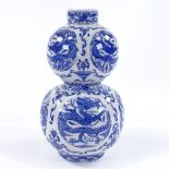 A Chinese blue and white porcelain double gourd vase, with dragon decorated panels, height 21cm