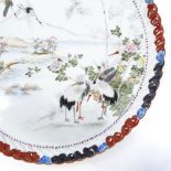 A Japanese porcelain tray with hand painted scene depicting cranes in mountain landscape, signed