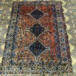 A Persian red ground Shiraz wool rug, bird and geometric decoration, 177cm x 127cm