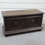 An 18th century Continental oak coffer, the relief carved front decorated with knights in armour,