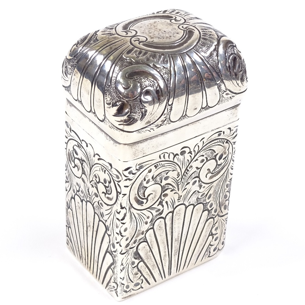 An Edwardian rectangular silver dome-top tea caddy, relief embossed fluted and foliate decoration,