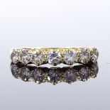 An unmarked gold 7-stone diamond half hoop ring, total diamond content approx 1.4ct, each diamond