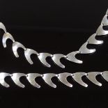 A Carl Ove Frydensberg Danish sterling silver matching necklace and bracelet, of plain boomerang