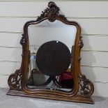 A carved and shaped walnut-framed over mantel mirror, circa 1900, height 3'11"