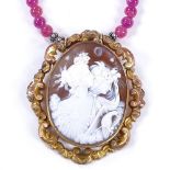 A relief carved cameo shell panel and polished pink amethyst necklace, depicting female busts, in