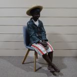 A life size painted plaster advertising shoeshine boy figure