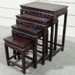A nest of Chinese hardwood occasional tables with carved friezes, largest table 20" x 14"