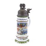 A Kaiser porcelain beer stein with transfer decorated military scenes, and pewter lid surmounted