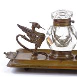 A Victorian brass desk stand, with original cut-glass inkwell flanked by griffon figures