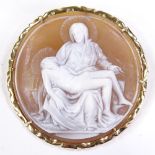 A relief carved circular cameo shell panel pendant/brooch, depicting Madonna and Christ, 14ct frame,