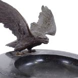 A 19th century polished marble bowl, surmounted by a bronze eagle with spread wings, unsigned,