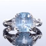 An 18ct white gold aquamarine and diamond dress ring, openwork shoulders and bridge, setting