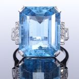 An Art Deco style large aquamarine and diamond dress ring, with round and baguette-cut stepped