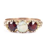 A 14ct rose gold 3-stone opal and garnet half-hoop ring, engraved foliate bridge and shoulders,