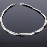 A Theodor Skat-Rorden Danish sterling silver necklace, eleven plain curved form panels, maker's