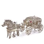 A Maltese unmarked silver filigree horse-drawn carriage model, rotating wheels and stone set