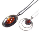 2 N.E. From Danish sterling silver and amber pendant necklaces, stylised form, circular pendant