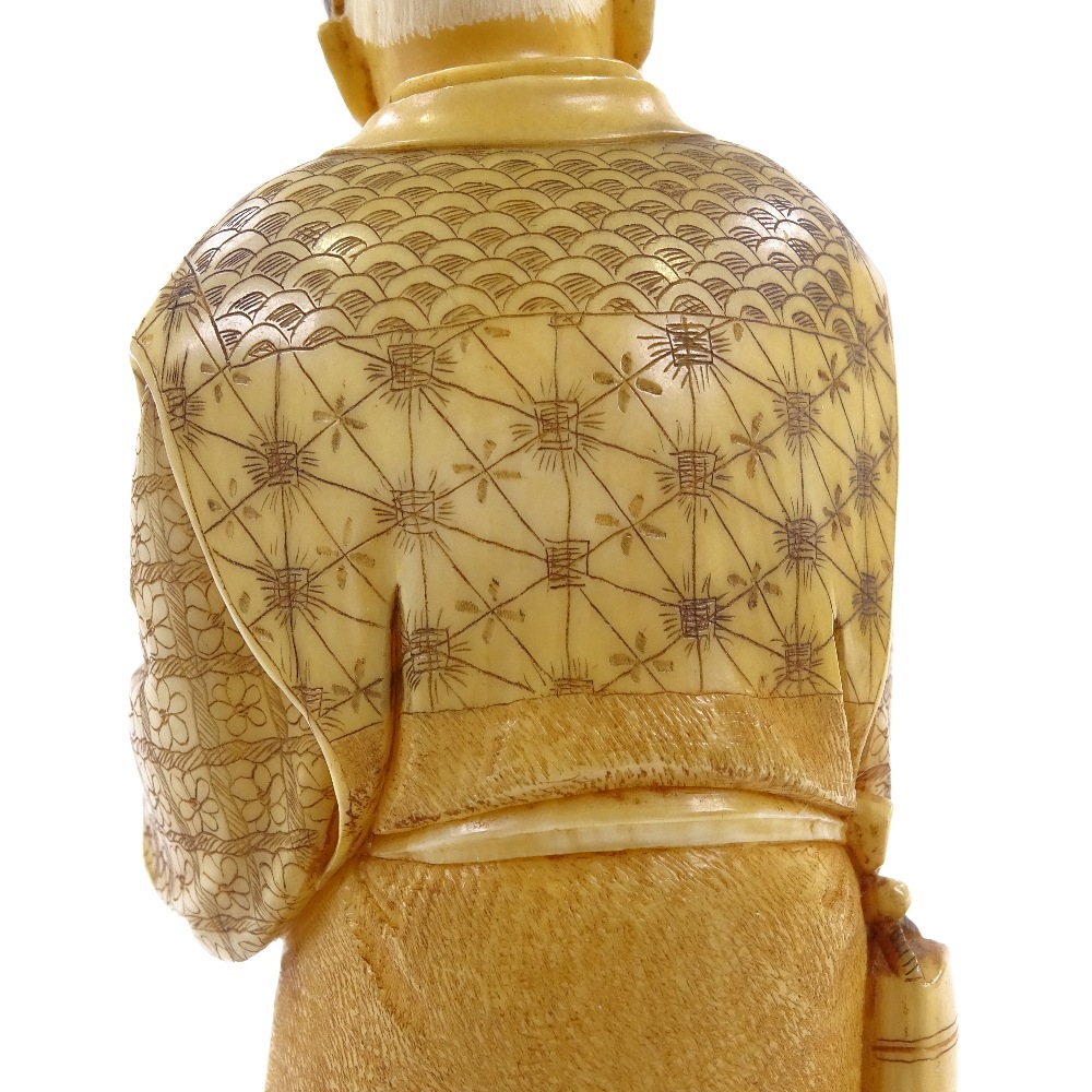 A Japanese 2-tone stained ivory okimono, man carrying an infant, Meiji period, signed under base, - Image 5 of 8