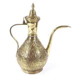 An Islamic brass wine ewer with relief embossed design, height 33cm
