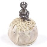 A novelty silver-mounted crinoline lady pin cushion, by Saunders & Shepherd, hallmarks Birmingham