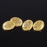A pair of 10ct gold oval cufflinks, foliate engraved panels, panel length 17.3mm, 5.2g