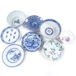 A group of Chinese porcelain bowls and plates, most chipped or repaired