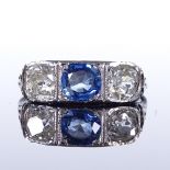An unmarked platinum 3-stone sapphire and diamond half-hoop panel ring, pierced shoulders and